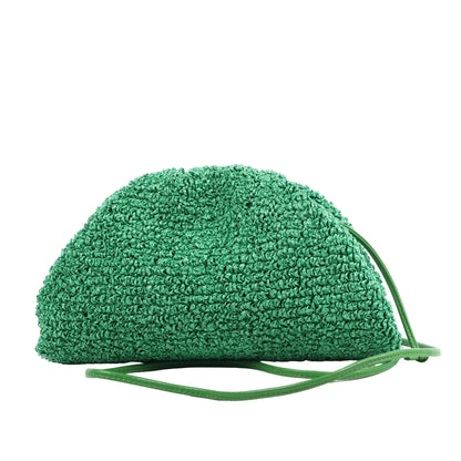 Bottega Veneta The Pouch Mini Crossbody bag in green raffia with a gathered top and slim green leather strap, shown against a white background.