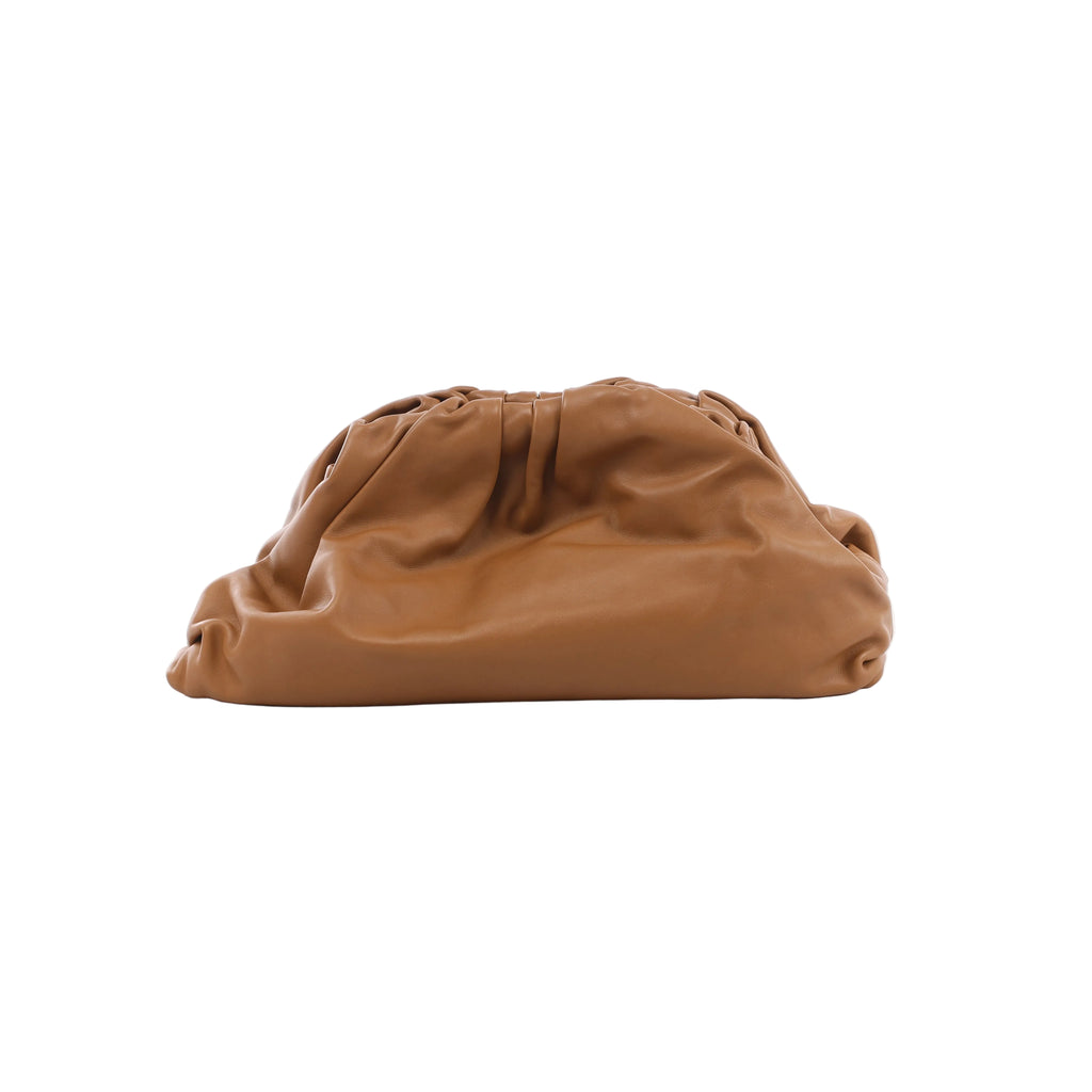 Oversized brown leather clutch bag with a soft slouchy shape, gathered top edge and smooth minimalist finish.
