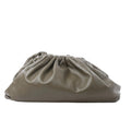 Bottega Veneta The Pouch Oversize green leather clutch with gathered ruched top and soft slouchy silhouette on white background