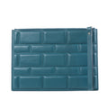 Bottega Veneta Blocs blue leather clutch bag with padded brick-effect panels, top zip closure and slim wrist strap on a white background.