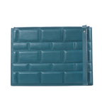 Bottega Veneta Blocs blue leather clutch bag with padded brick-effect panels, top zip closure and slim wrist strap on a white background.