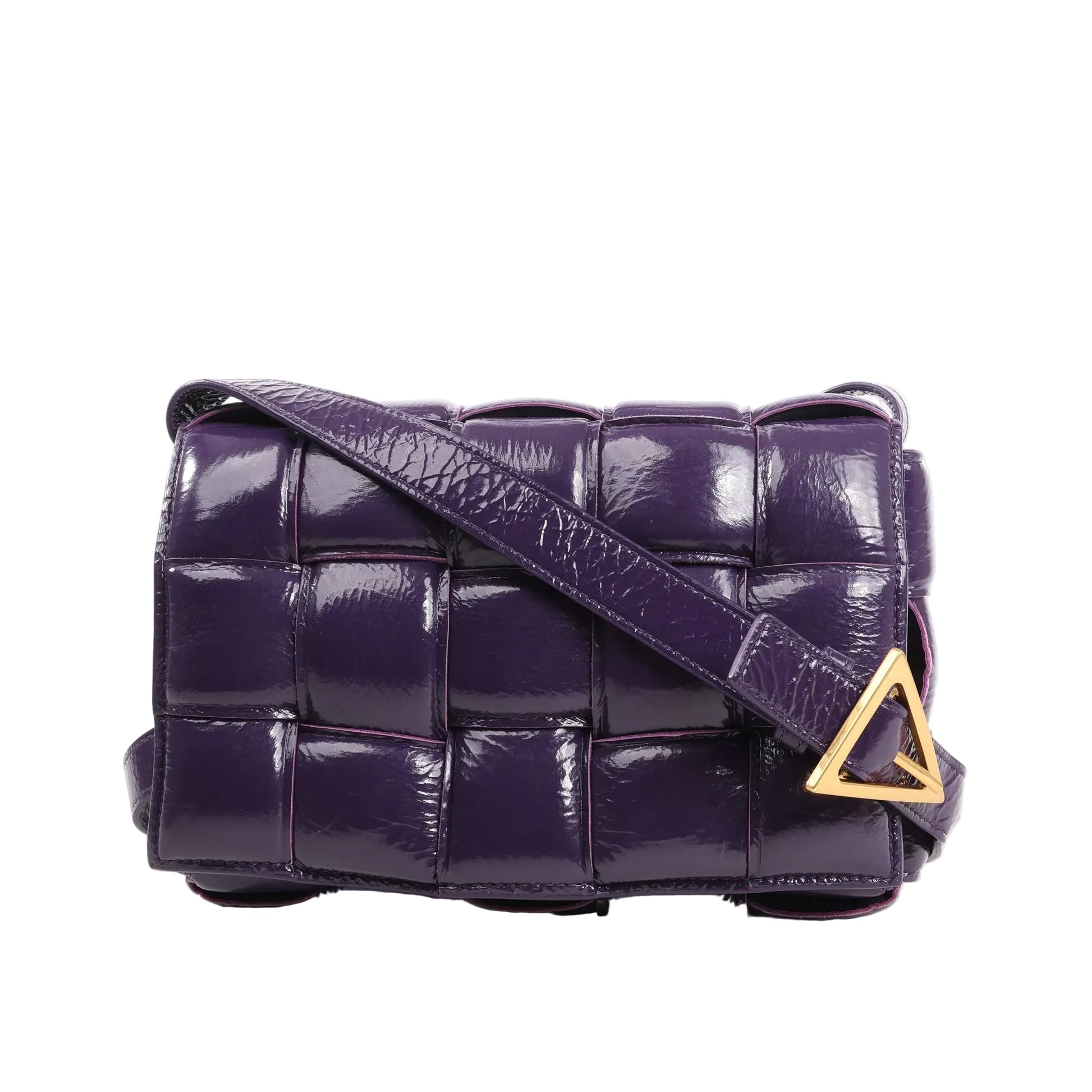 Front view of the Bottega Veneta Padded Cassette Maxi Intrecciato shoulder bag in glossy purple patent leather, featuring large woven panels, a matching strap, and a gold-tone triangle buckle.