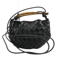 Bottega Veneta Intrecciato Sardines Leather Shoulder Bag in black with a gold-tone handle and adjustable straps, showcasing the woven leather design.