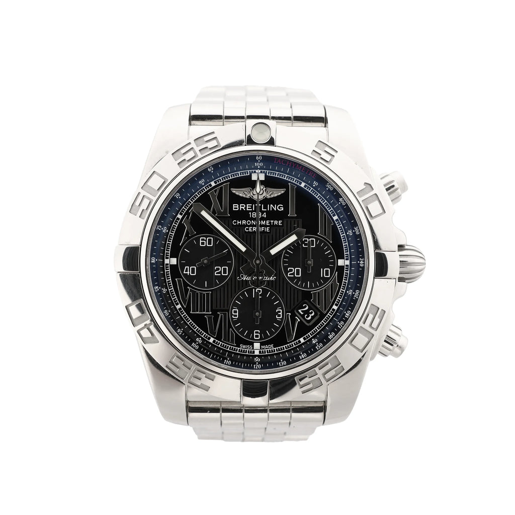 Close-up of Breitling Chronomat stainless steel watch with black Roman-numeral dial, three chronograph subdials, tachymeter ring, engraved bezel and date window.