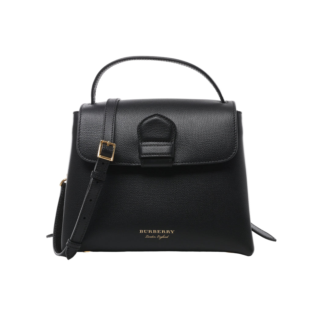 Black Burberry Camberley leather top handle bag with structured flap, shoulder strap, gold-tone buckle hardware and Burberry logo lettering.