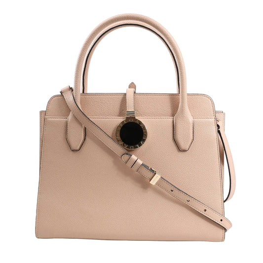 BVLGARI ALBA 2-way handbag in beige grained leather featuring top handles, detachable shoulder strap, structured shape, and gold-tone circular logo charm with black enamel center.