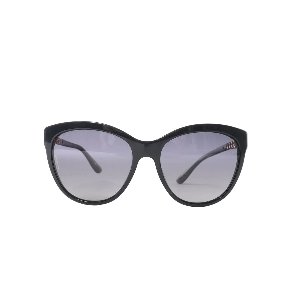 Bvlgari BV8158 black cat-eye sunglasses with gray tinted lenses, glossy frame, slim curved temples and subtle gold-tone branding on white background.