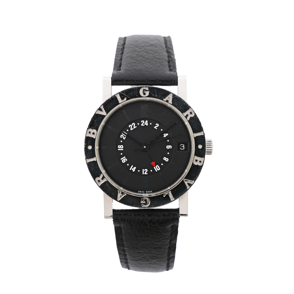 Front view of a Bvlgari Bvlgari watch with a black dial, white 24-hour scale, red-tipped GMT hand, engraved bezel and black leather strap.
