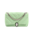 BVLGARI Serpenti Cabochon crossbody bag in light green quilted leather with silver-tone chain strap and black-and-white Serpenti snakehead clasp, front view on white background.