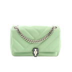 BVLGARI Serpenti Cabochon crossbody bag in light green quilted leather with silver-tone chain strap and black-and-white Serpenti snakehead clasp, front view on white background.