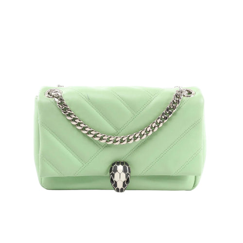 BVLGARI Serpenti Cabochon crossbody bag in light green quilted leather with silver-tone chain strap and black-and-white Serpenti snakehead clasp, front view on white background.