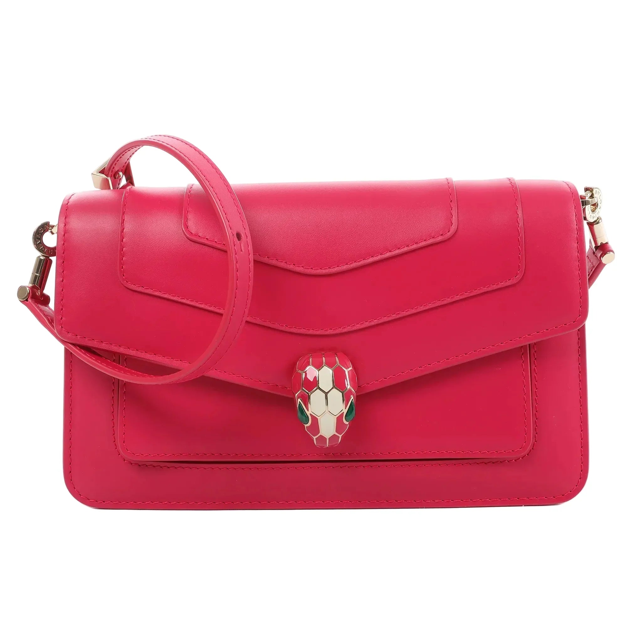 BVLGARI Serpenti Forever pink leather crossbody bag with flap front, enamel snakehead clasp, and adjustable shoulder strap on a white background.