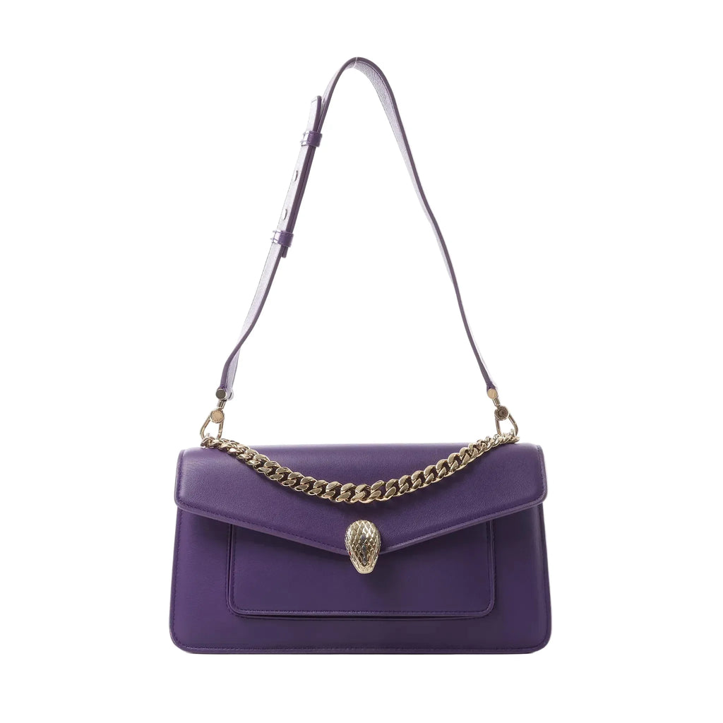Bvlgari Serpenti purple leather shoulder bag with gold-tone chain detail and snake head clasp, shown with long adjustable strap on white background.