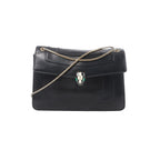 Black leather BVLGARI Serpenti flap bag with gold-tone chain strap and Serpenti head clasp on white background.