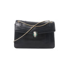Black leather BVLGARI Serpenti flap bag with gold-tone chain strap and Serpenti head clasp on white background.