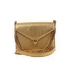 BVLGARI Serpenti gold textured leather crossbody bag with flap closure, snakehead clasp, and gold chain strap on a white background.