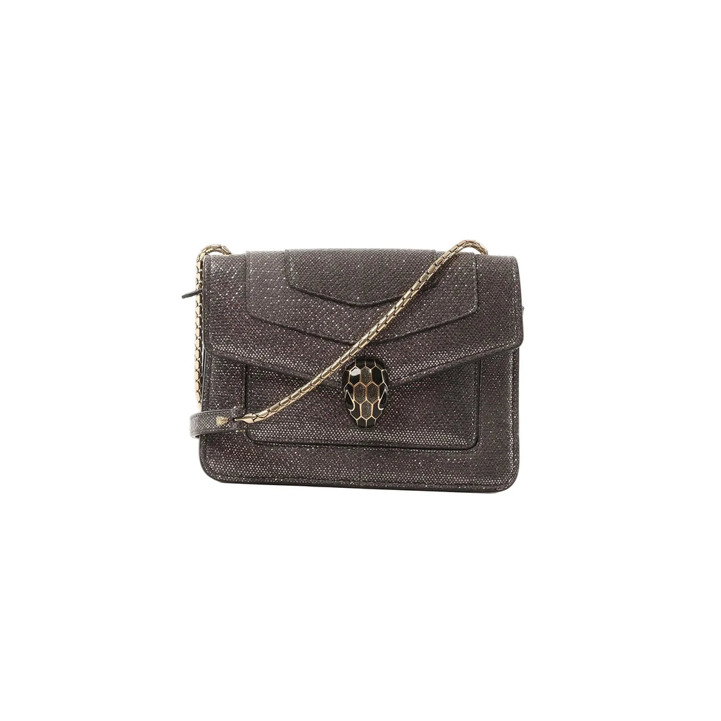 BVLGARI Serpenti gray glitter leather crossbody bag with gold-tone chain strap and black-and-gold serpent head clasp, front view on a white background.
