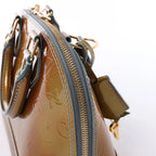 Bolso de mano Louis Vuitton Alma BB Monogram Vernis 2Way en dorado M91677