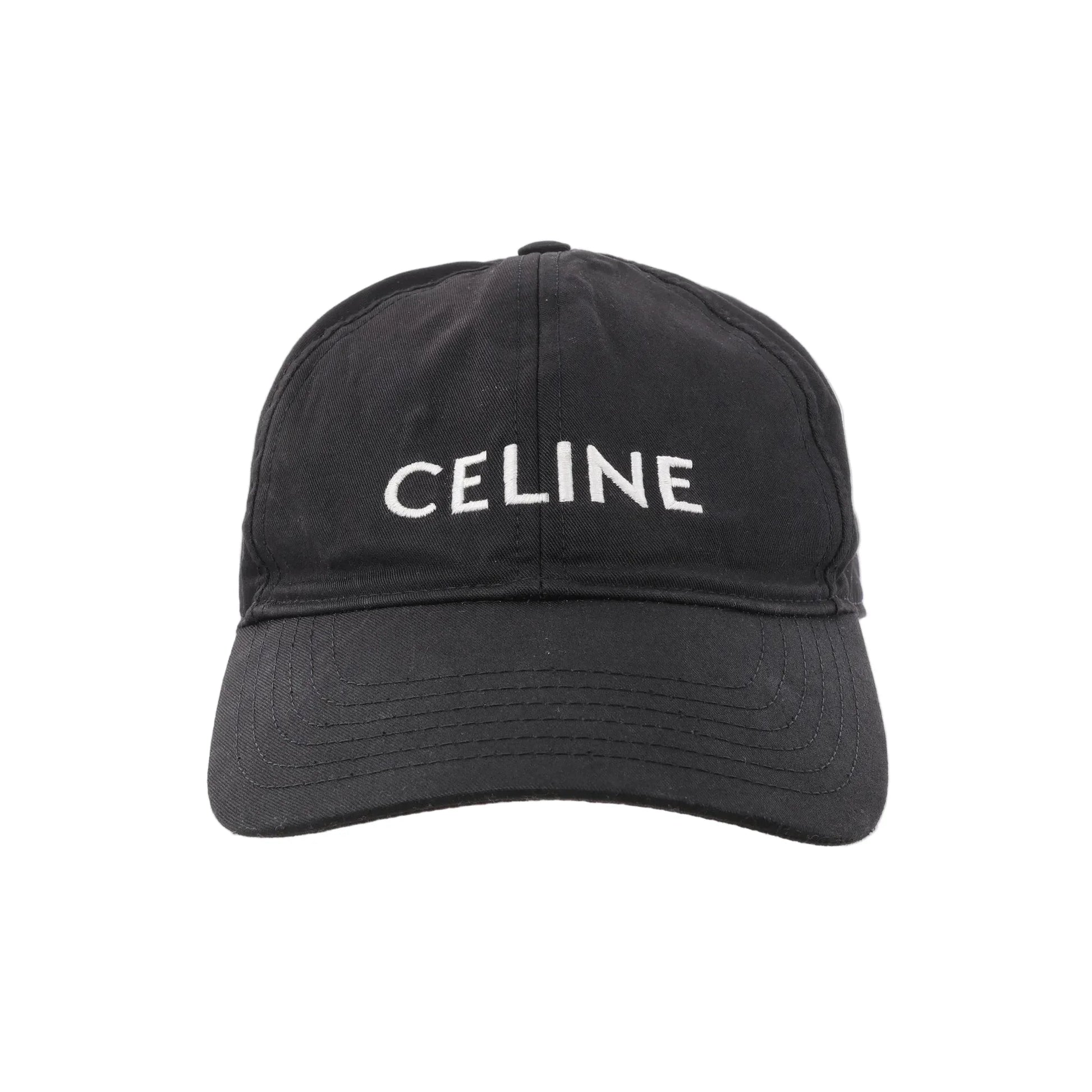 CELINE black cotton baseball cap with white embroidered CELINE logo on the front and a curved brim, shown from the front against a white background.
