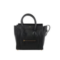 Black Celine Luggage Micro leather handbag with structured top handles, winged sides, front zip pocket and gold-tone logo detailing.