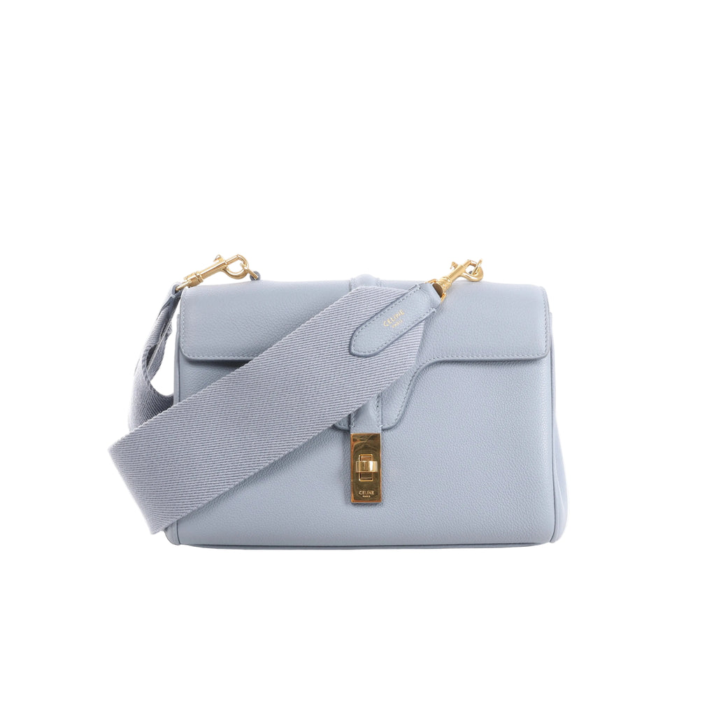 Light blue CELINE Soft 16 Teen leather shoulder bag with wide tonal textile strap, structured flap and gold-tone clasp hardware.