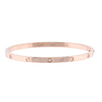 Cartier Love SM rose gold bangle bracelet with screw motifs and small diamond accents on a white background