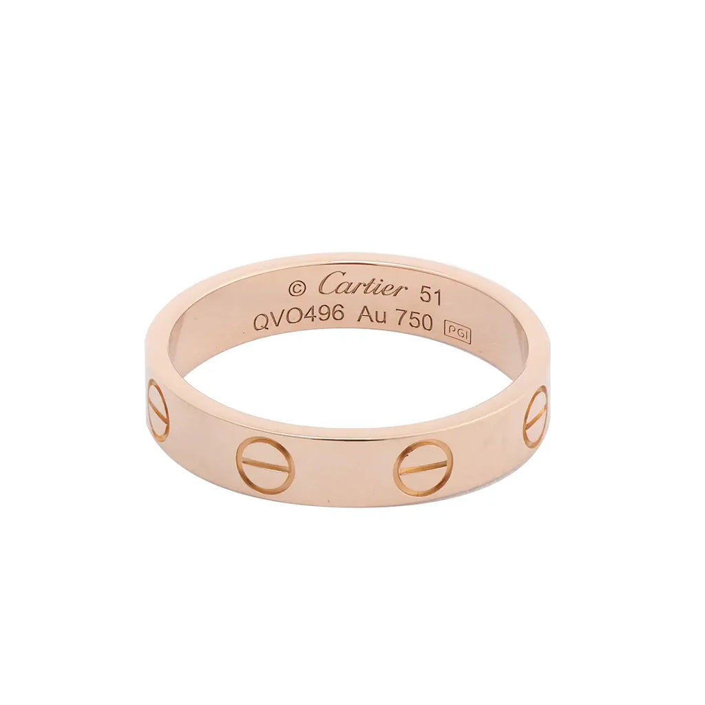 Cartier Mini Love ring in polished 18K pink gold with engraved screw motifs around the band and interior engraving.