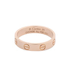 Cartier Mini Love ring in polished 18K pink gold with engraved screw motifs around the band and interior engraving.