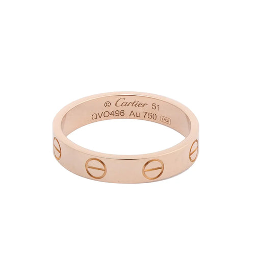 Cartier Mini Love ring in polished 18K pink gold with engraved screw motifs around the band and interior engraving.