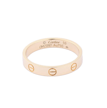 Cartier Mini Love Ring in 18K yellow gold featuring engraved screw motifs around the band, inner hallmark engraving, size 59, model OMZ097, weight 3.7g.