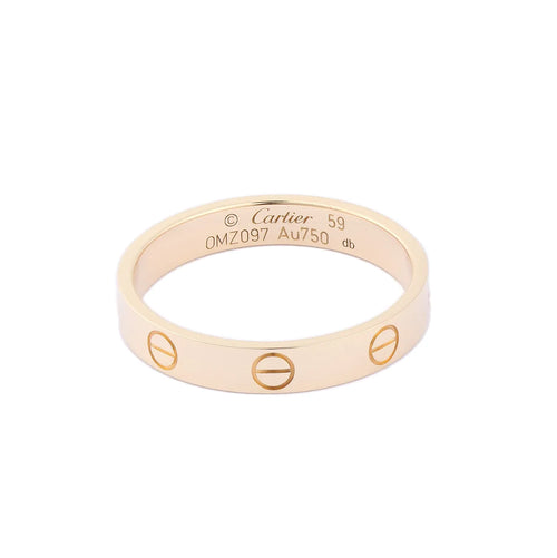 Cartier Mini Love Ring in 18K yellow gold featuring engraved screw motifs around the band, inner hallmark engraving, size 59, model OMZ097, weight 3.7g.
