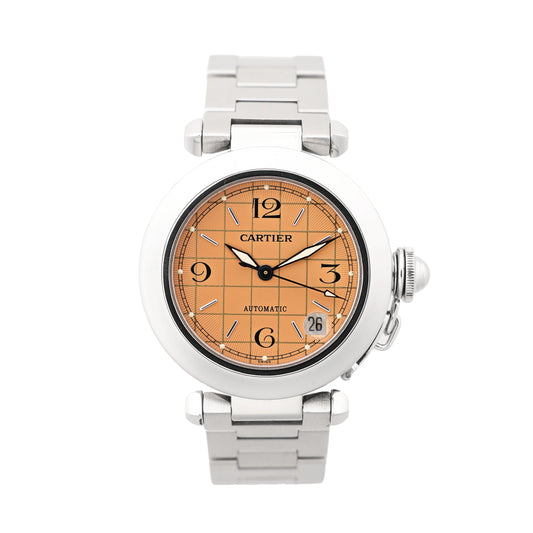 Cartier Pasha W31024M7 stainless steel automatic watch featuring a round case, orange guilloché-pattern dial with black Arabic numerals, silver hands, date window at 4 o’clock, and stainless steel bracelet, displayed on a white background.