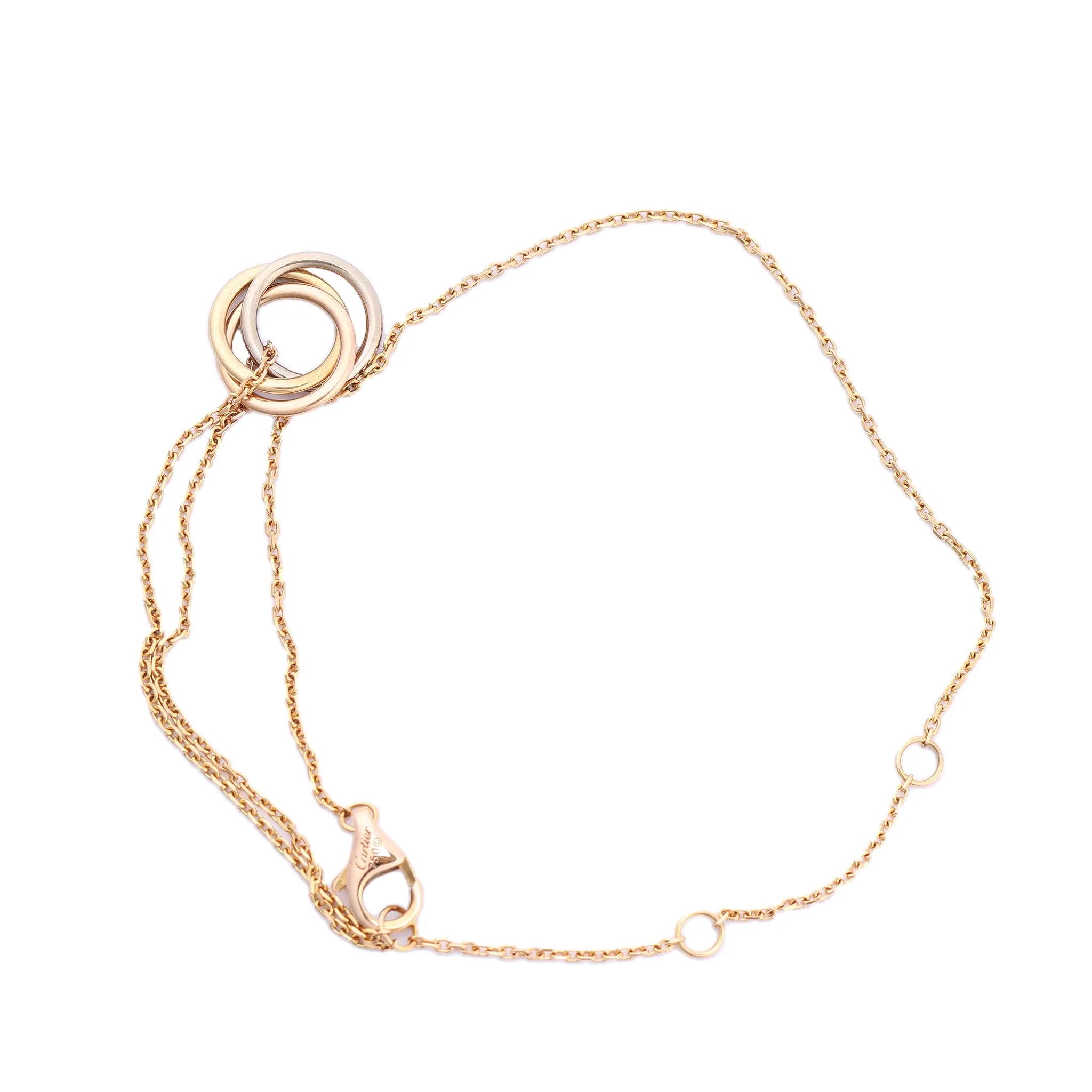 Cartier Sweet Trinity bracelet featuring interlocking 18K yellow, pink, and white gold rings on a fine yellow gold chain with adjustable loops and lobster clasp, model RV3751, weight 2.2g.