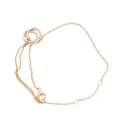 Cartier Sweet Trinity bracelet featuring interlocking 18K yellow, pink, and white gold rings on a fine yellow gold chain with adjustable loops and lobster clasp, model RV3751, weight 2.2g.