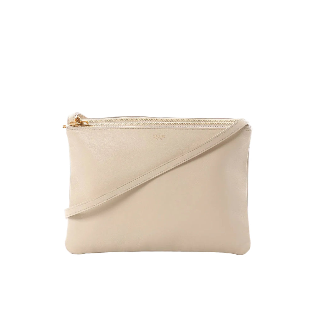 Celine Trio Large beige leather crossbody bag with gold-tone zip-top closure, slim shoulder strap, and small logo stamp on front