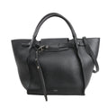 Black CELINE Big Bag Small grained leather handbag with top handles, belted strap detail, and shoulder strap on white background