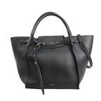 Black CELINE Big Bag Small grained leather handbag with top handles, belted strap detail, and shoulder strap on white background