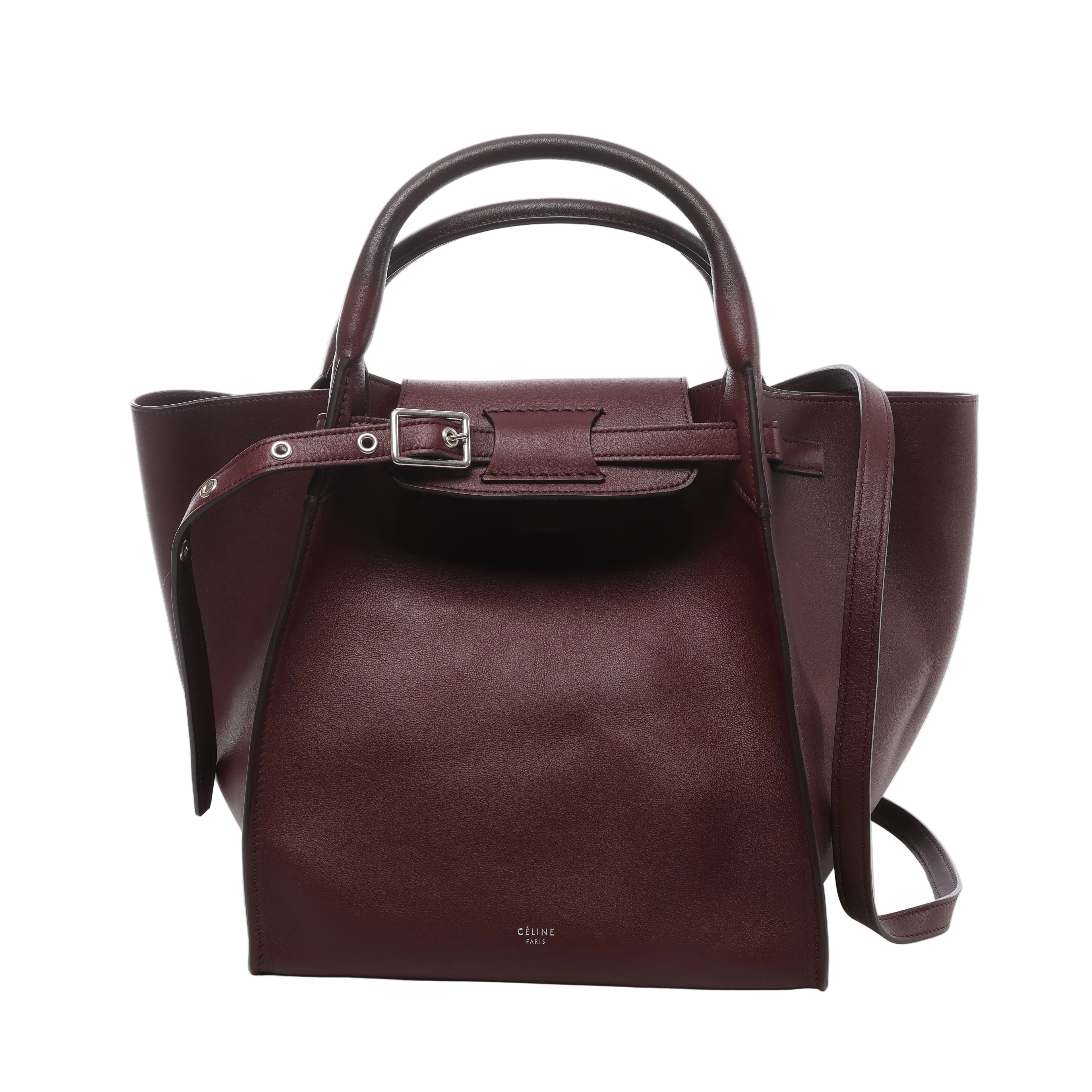 Burgundy Celine Big Bag Small leather handbag with rounded top handles, long shoulder strap, belted front closure and silver-tone buckle hardware.