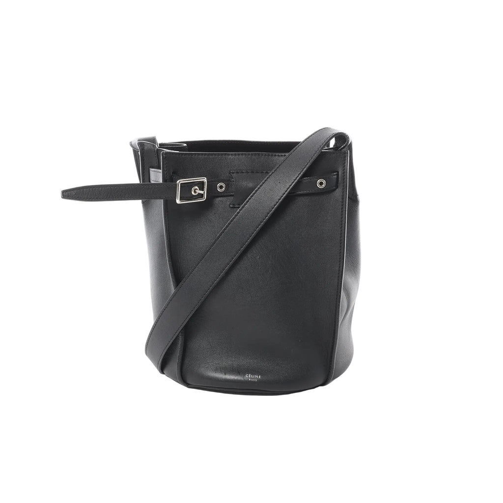 Minimalism with presence. The Céline Big Bag Bucket in black leather features a clean, sculptural shape with a belted detail and shoulder strap—an elevated everyday piece that feels quietly confident.