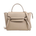 CELINE Belt Bag Micro 2Way Handbag in beige grained leather, showcasing a structured design with a top handle, knotted front belt detail, winged sides, and a detachable shoulder strap, displayed against a white background.