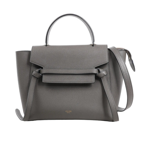 CELINE Belt Bag Micro in gray grained calfskin leather with top handle, flap front, knotted belt detail, and detachable shoulder strap, displayed against a white background.