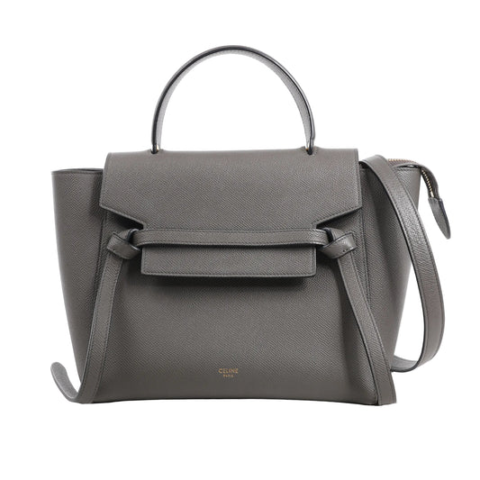 CELINE Belt Bag Micro in gray grained calfskin leather with top handle, flap front, knotted belt detail, and detachable shoulder strap, displayed against a white background.