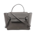 Gray Celine Mini Belt Bag with textured leather, single top handle, long shoulder strap, structured winged sides and front flap tie detail.
