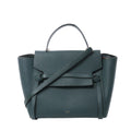 Front view of Celine Belt Bag Mini in green grained leather with top handle, long shoulder strap, flap closure with belt detail, and small gold “CELINE PARIS” logo.