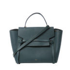 Front view of Celine Belt Bag Mini in green grained leather with top handle, long shoulder strap, flap closure with belt detail, and small gold “CELINE PARIS” logo.