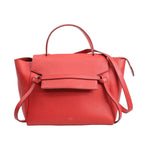 Celine Belt Bag Mini in red grained leather with a structured top handle, front flap with signature knotted belt design, and detachable shoulder strap, set against a white background.