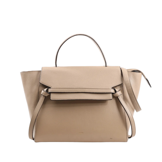 CELINE Belt Bag Mini in beige grained leather, showcasing a structured design with a top handle, signature knotted front belt detail, winged sides, and a detachable shoulder strap, photographed against a white background.