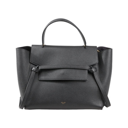 Front view of a Celine Belt Bag Mini in black grained leather featuring a top handle, flap closure with signature belt detail, and side wings, with a detachable shoulder strap for 2-way use.