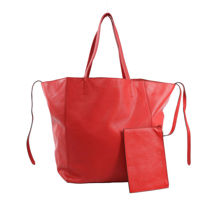 Celine Cabas Phantom Large Shoulder Bag in red grained leather with double top handles, side leather tie accents, and matching zip pouch, displayed upright against a white background.