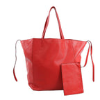 Celine Cabas Phantom Large Shoulder Bag in red grained leather with double top handles, side leather tie accents, and matching zip pouch, displayed upright against a white background.
